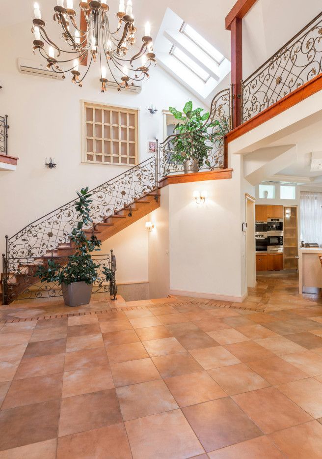 Swansea house featuring luxury tiled floors and a wooden staircase.